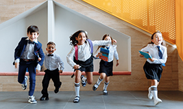 children in uniform running